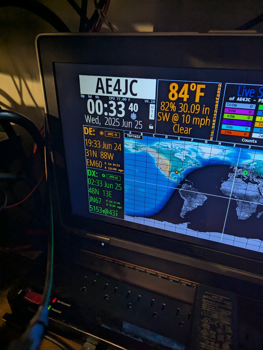 Shack monitor showing station callsign, grid square, and live conditions