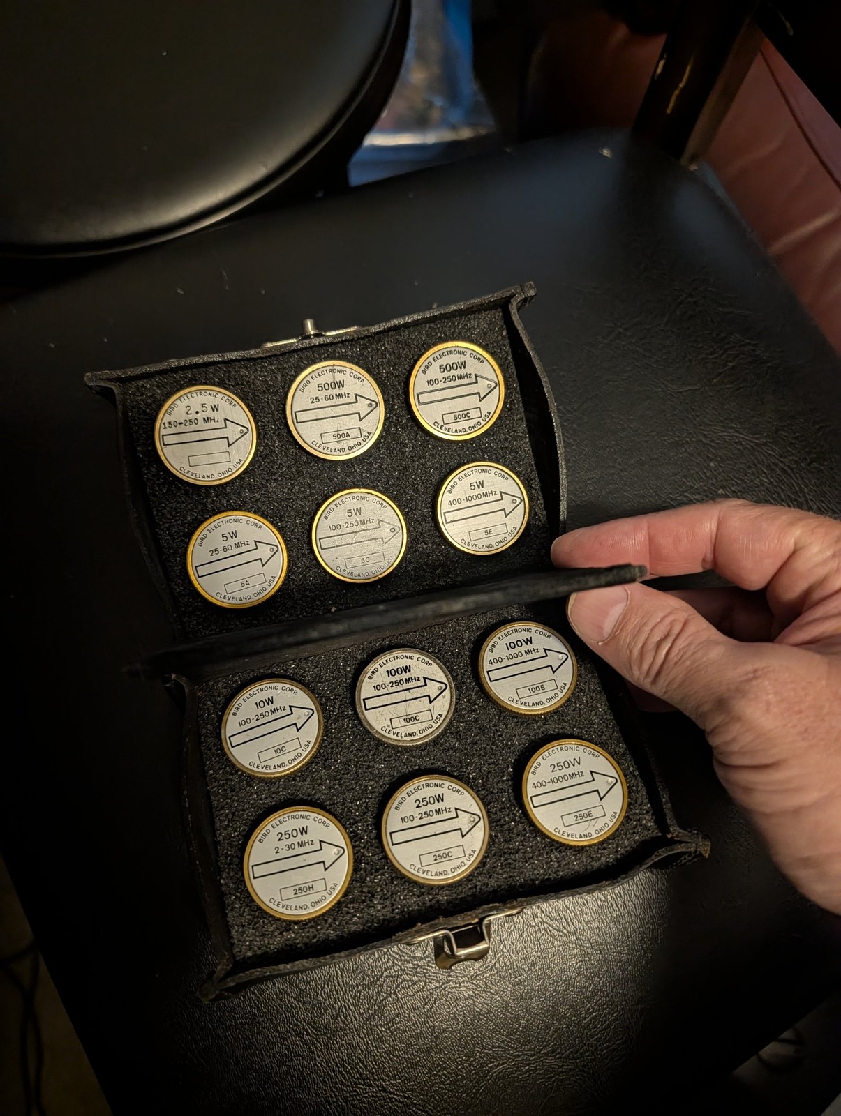 An open Bird Electronic Corp wattmeter slug case holding a dozen power/frequency elements ranging from 2.5W to 500W across HF, VHF, and UHF